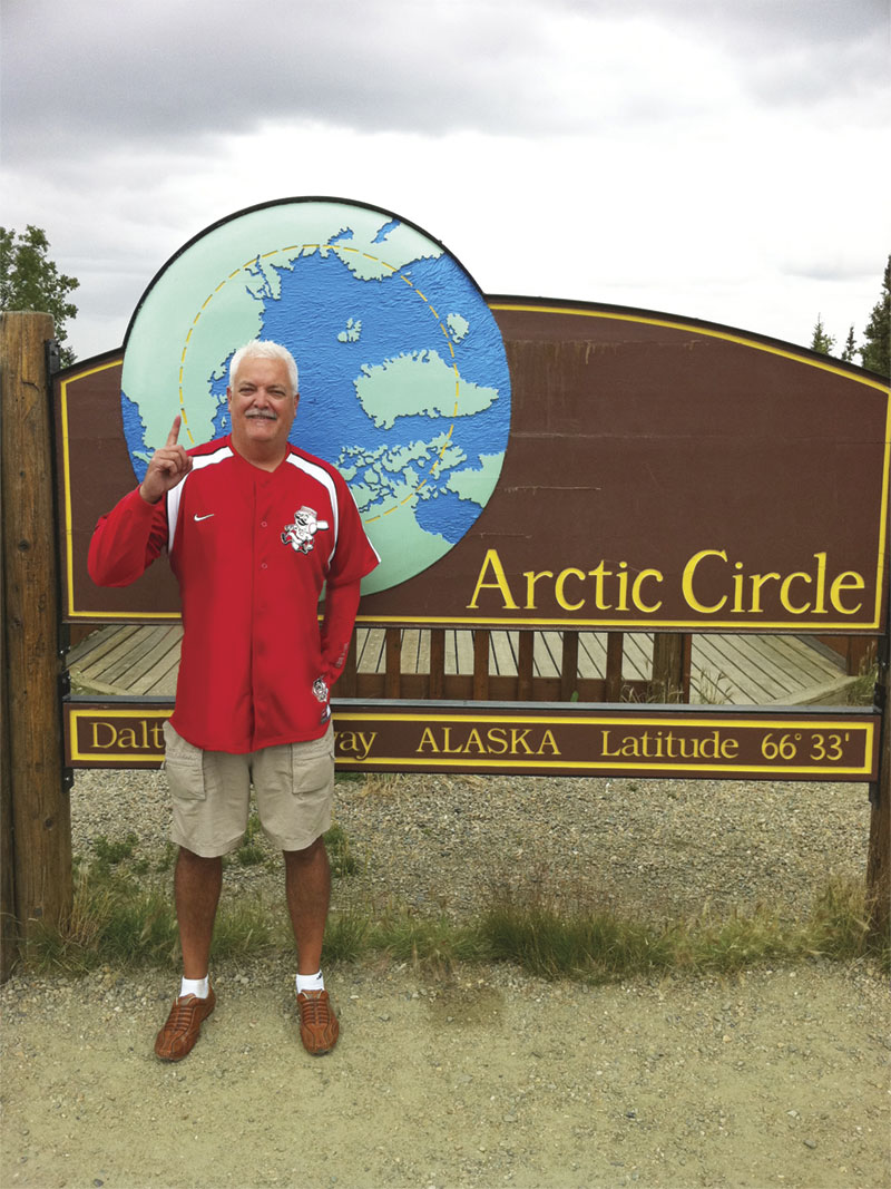 Founder, Tim Parks, standing in front of the sign for the Arctic Circle
